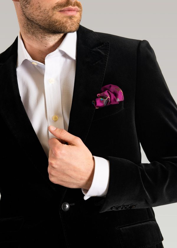 Men's formal wear black velvet jacket styled with a white shirt and silk pocket square
