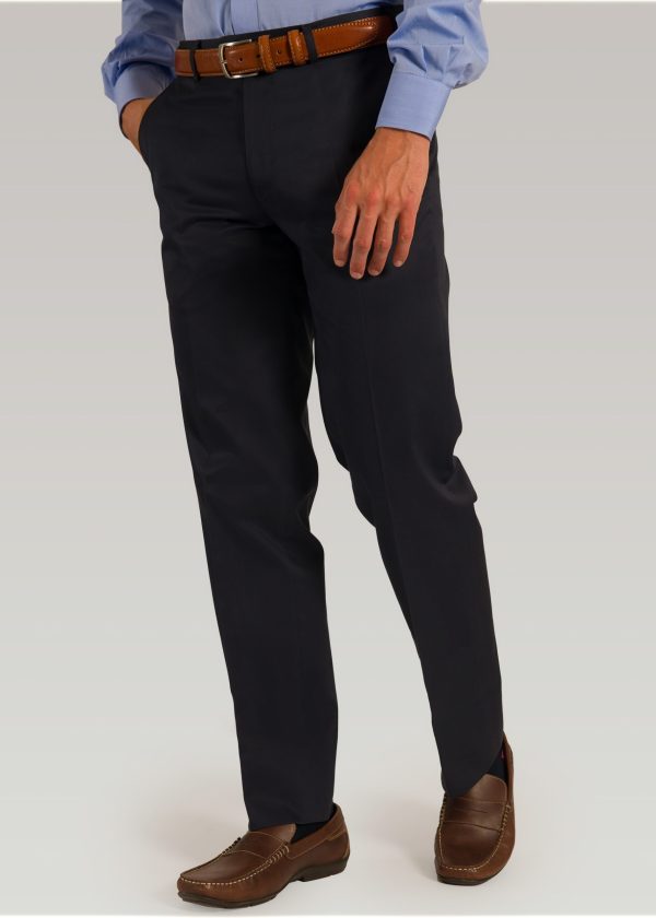 Navy cotton trousers styled with light blue shirt and brown leather belt