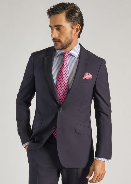 Men's formal plain navy suit styled with white shirt and pink tie