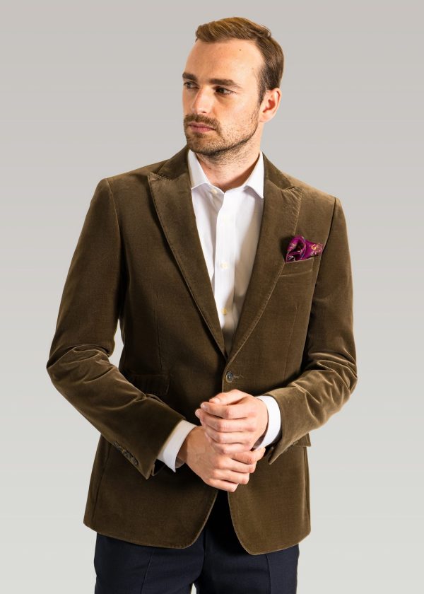 Men's formal velvet jacket in olive green and styled with a silk pocket square