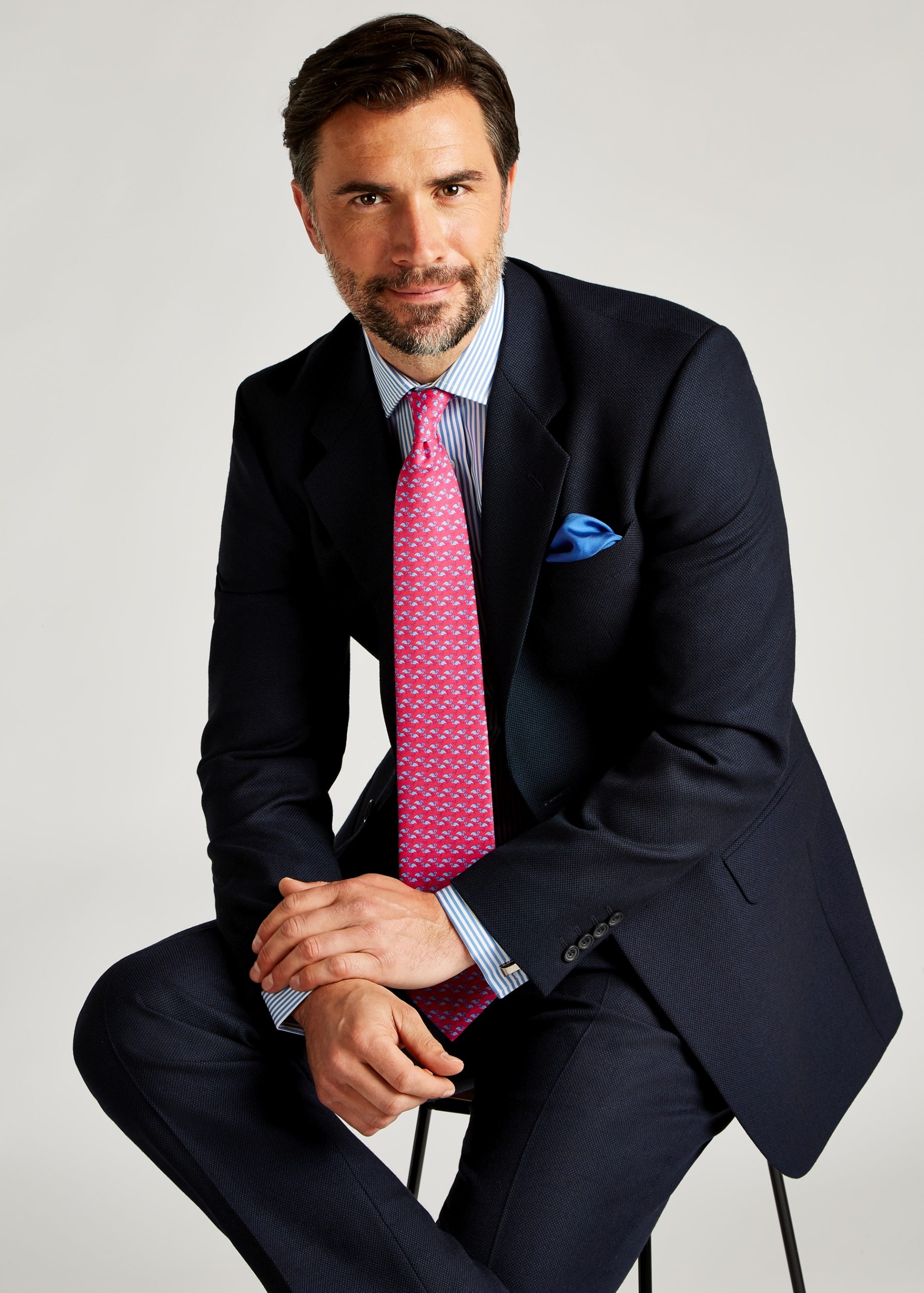 Roderick Charles classic fit navy birdseye suit styled with a blue stiped shirt and pink tie
