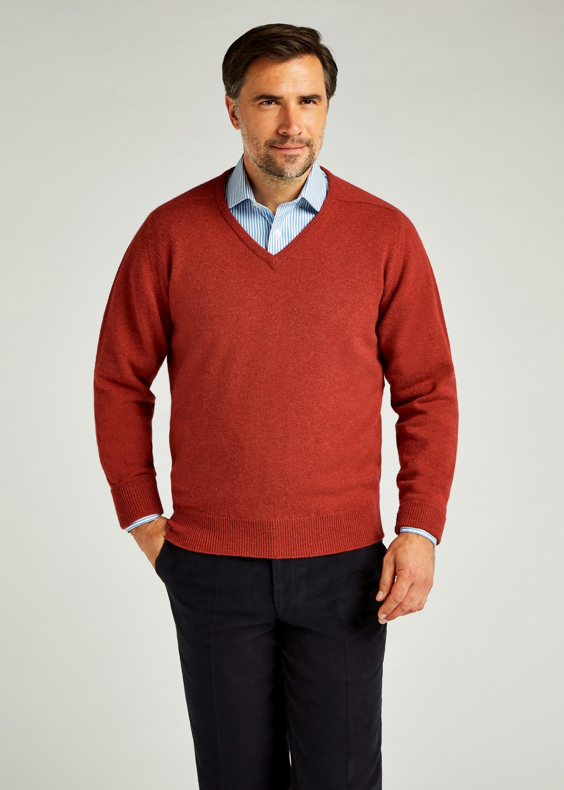 V neck poppy sweater styled with open collar shirt