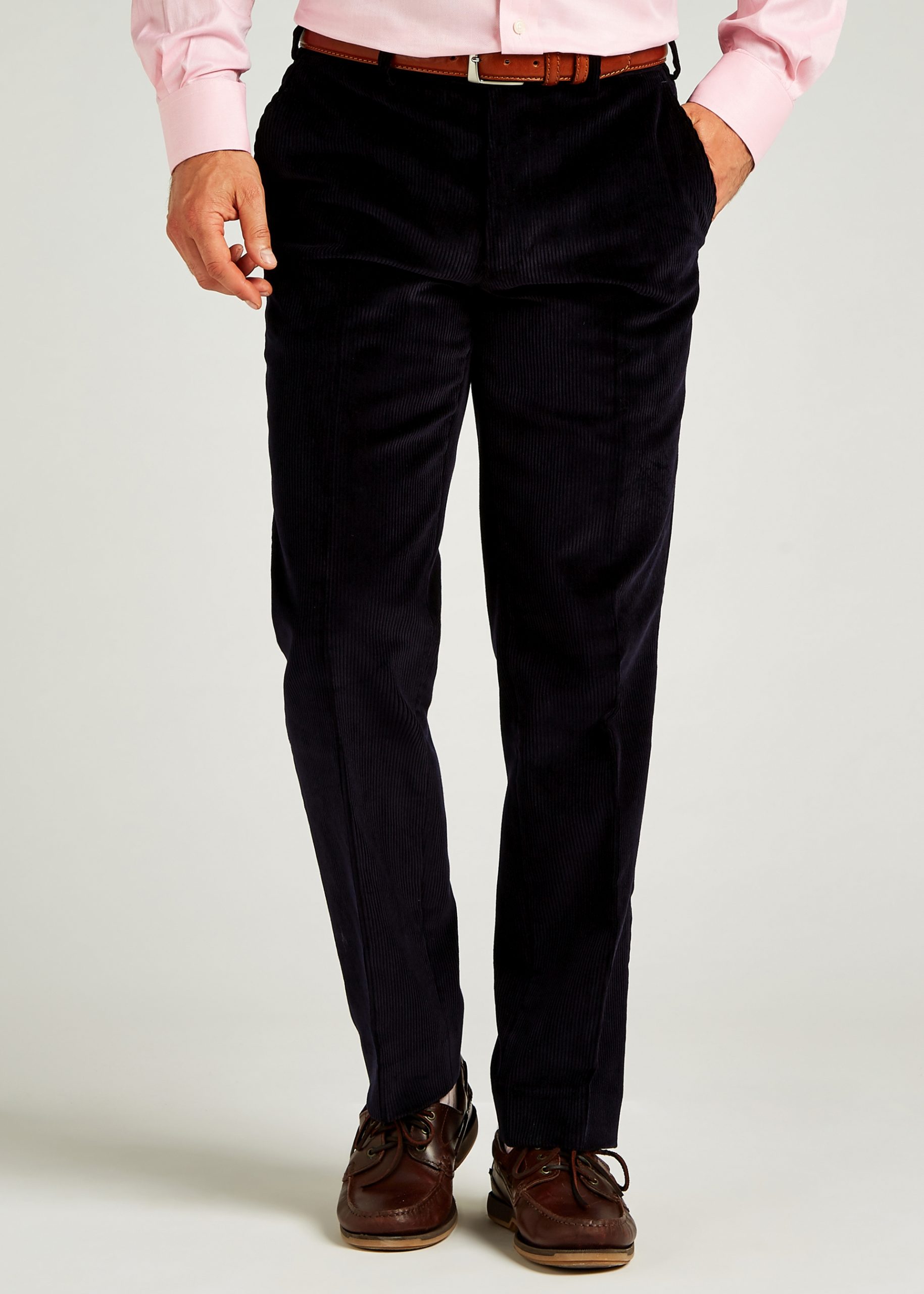 Navy corduroy trousers styled with brown leather belt