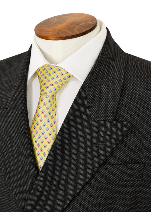 Double breasted grey suit styled with white shirt and yellow tie