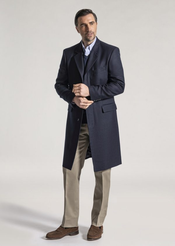 Navy long overcoat styled with white shirt and blue tie