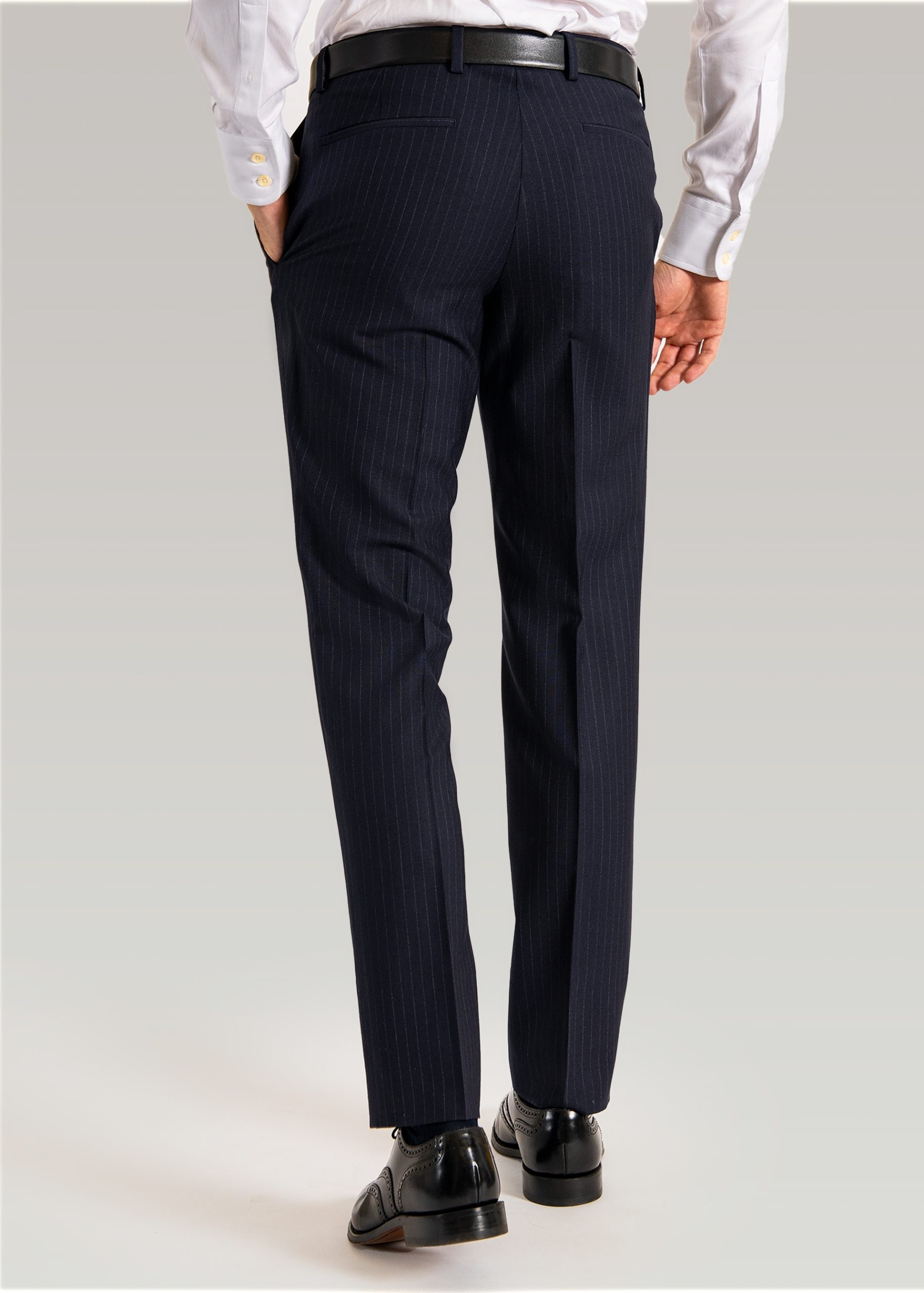Formal navy striped suit trousers styled with black brogues