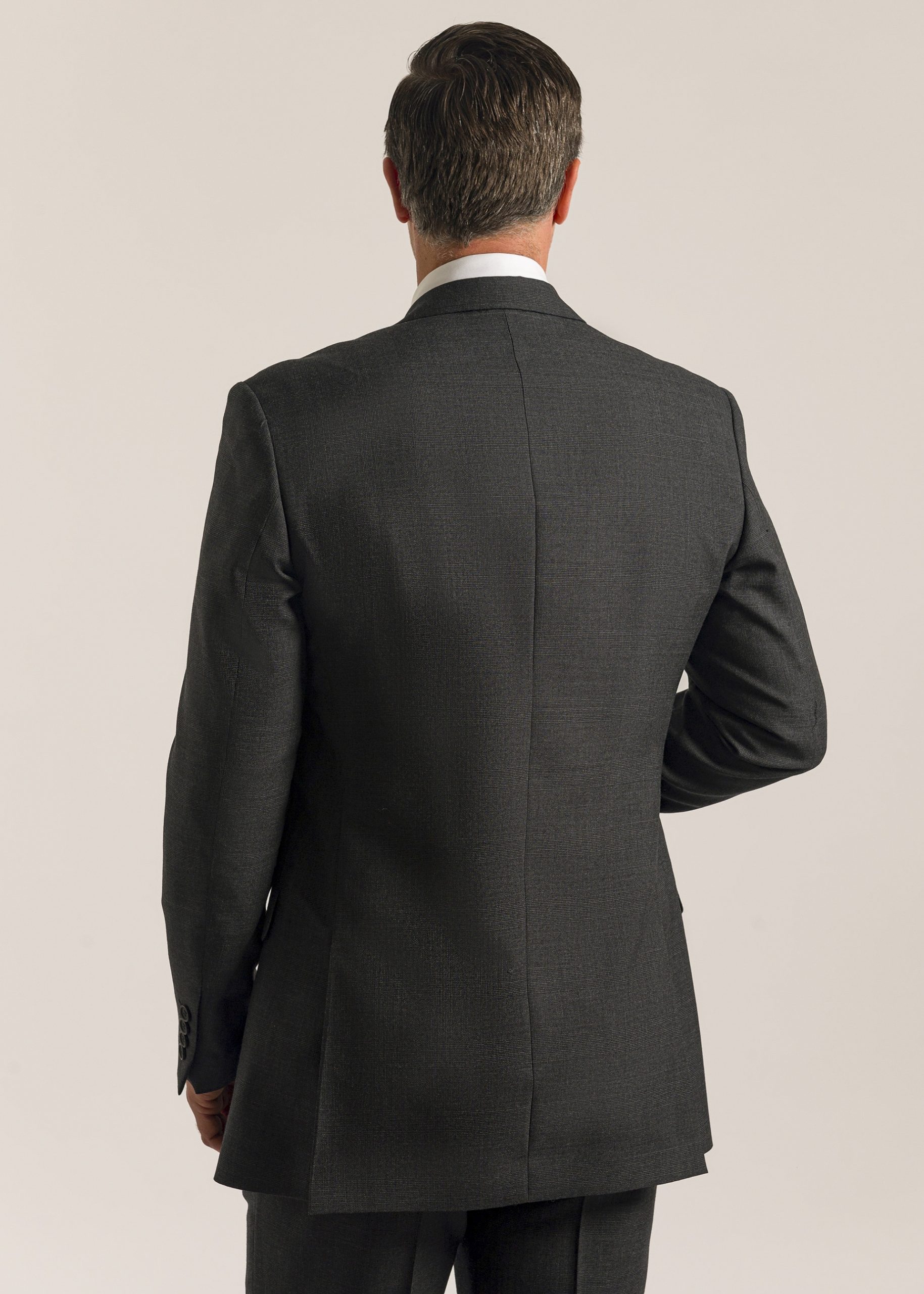 Back of men’s formal grey Glen check suit jacket