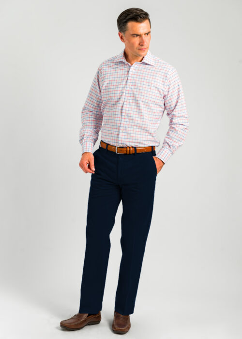 A lightweight men's cotton chino trouser in navy by Roderick Charles, styled with checked shirt.