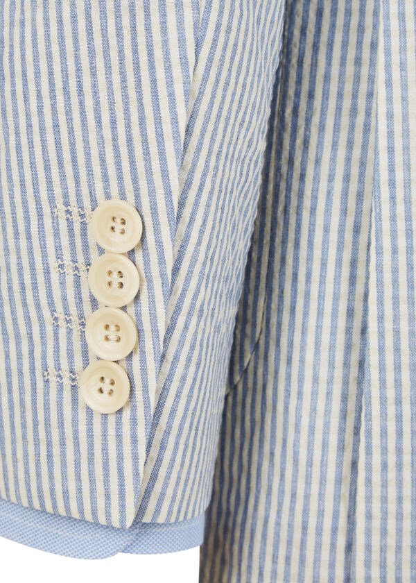 4 button faux-cuff sleeve of a tailored light blue striped seersucker jacket