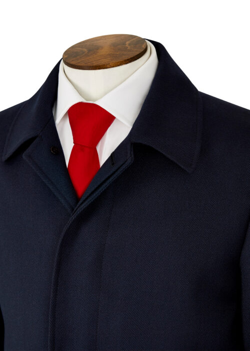 A single-breasted Roderick Charles three-quarter length navy herringbone coat