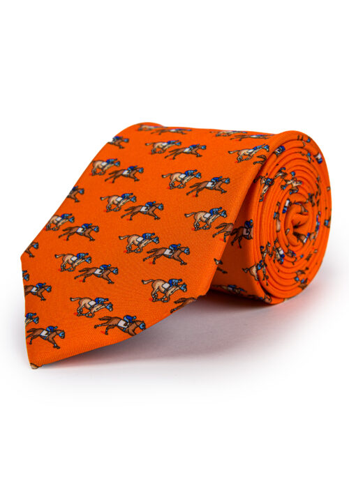 A rolled up Roderick Charles orange silk tie depicting horse racing horses and jockeys