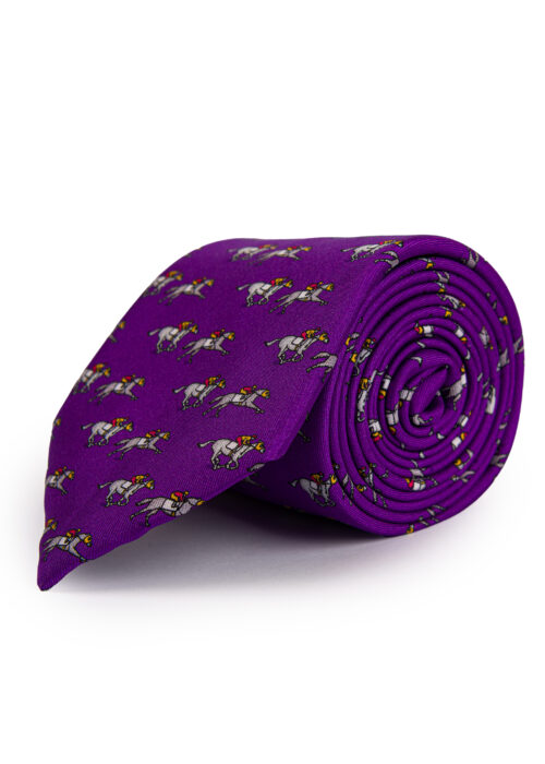 A rolled up Roderick Charles purple silk tie depicting horse racing horses and jockeys