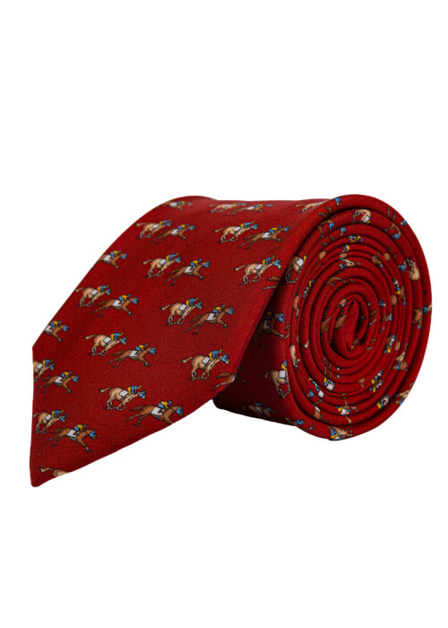 A rolled up Roderick Charles red silk tie depicting horse racing horses and jockeys