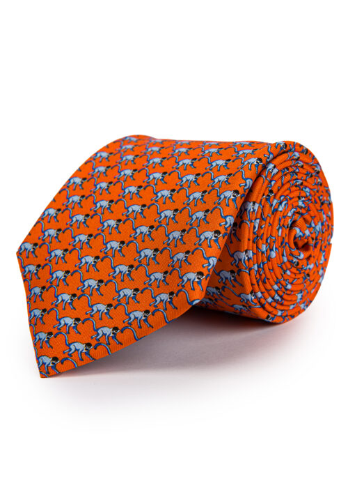 A rolled up Roderick Charles orange silk monkey tie